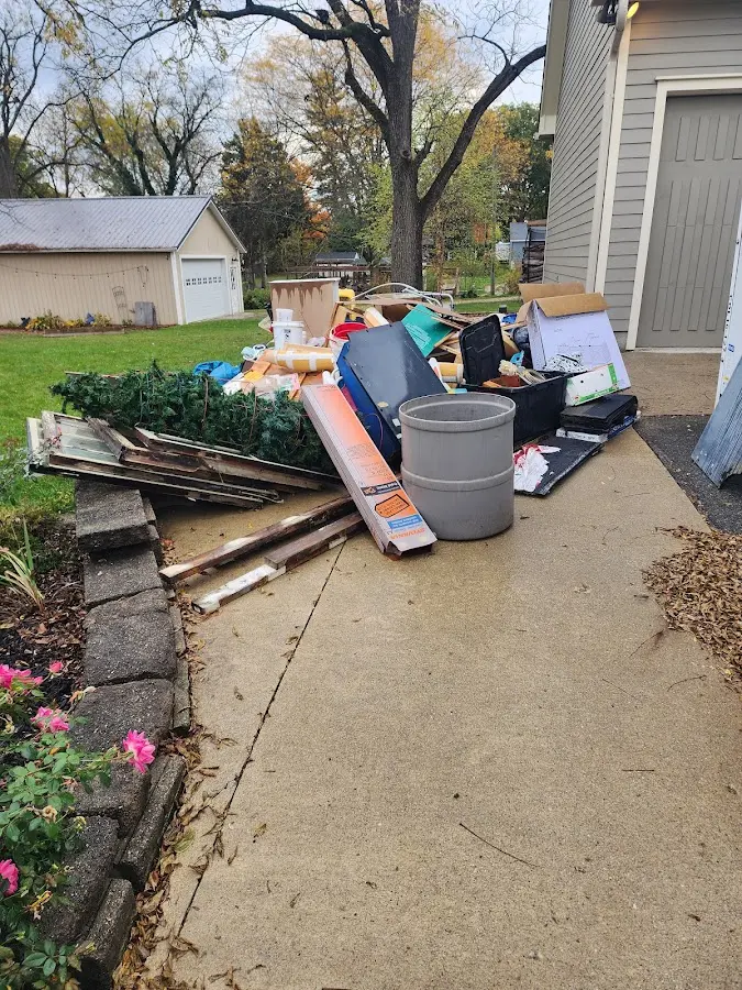 Dumpster being loaded with debris for 12 Yard Dumpster Rental in San Angelo